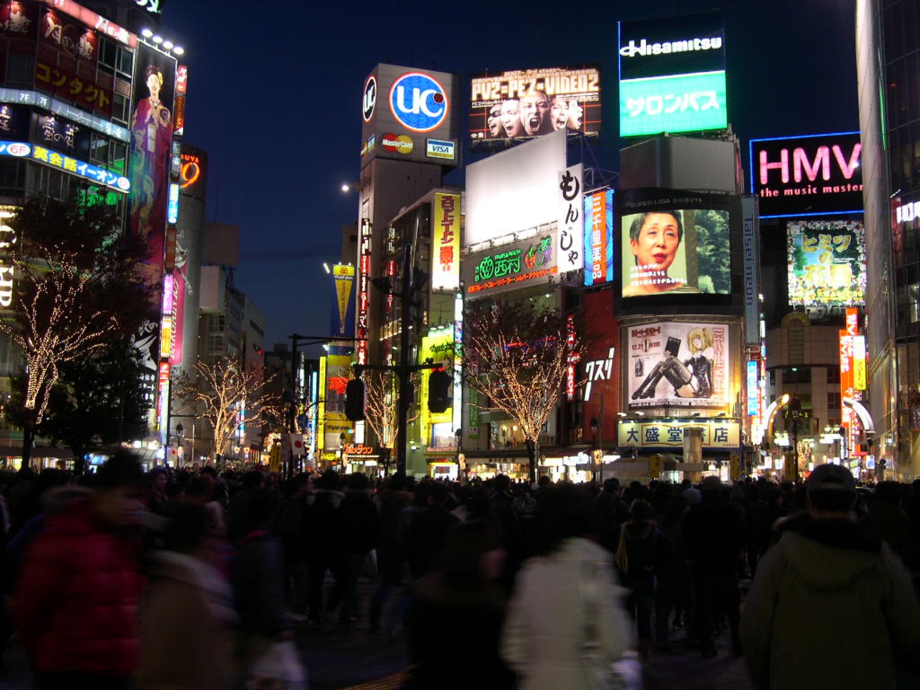 Shibuya at night with illuminated buildings and street traffic
