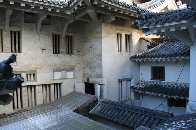 The white main keep of Himeji Castle seen across its stone walls